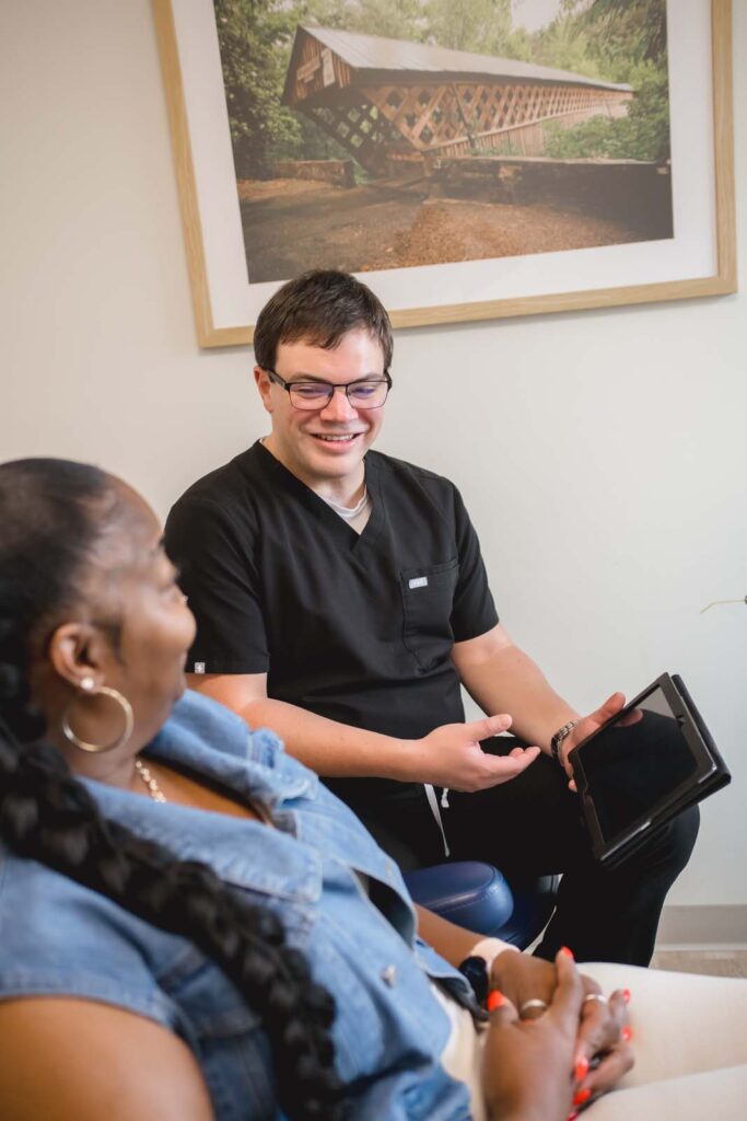 Doctor showing the patient dental procedures